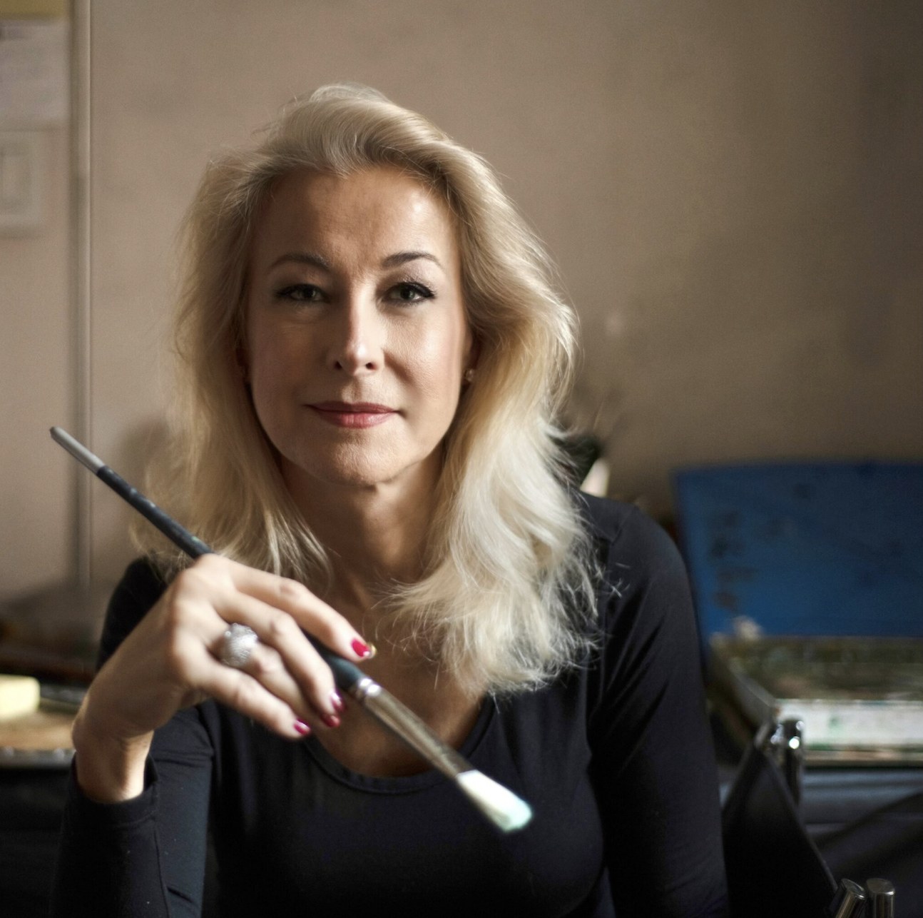 Luisa López Celada in the studio, holding a brush